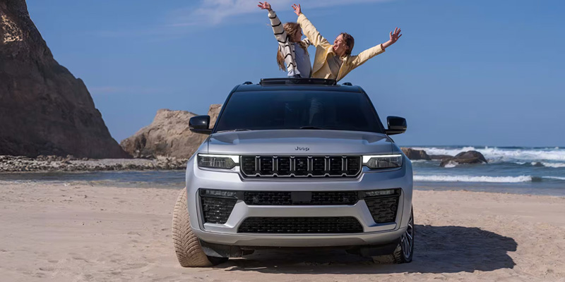 2026 Jeep Grand Cherokee midsize SUV driving on Baytown roads.